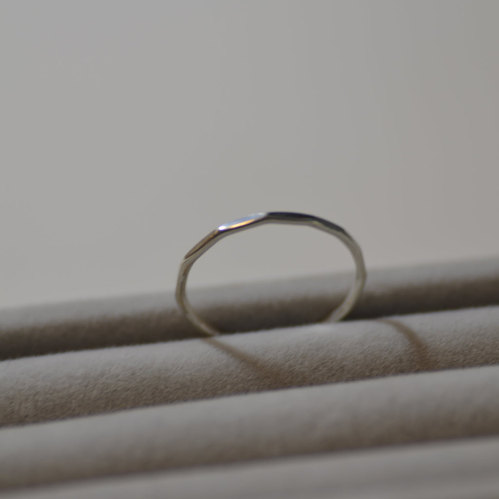 Close-up of a silver ring on a plain background