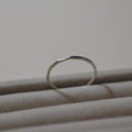 Close-up of a silver ring on a plain background