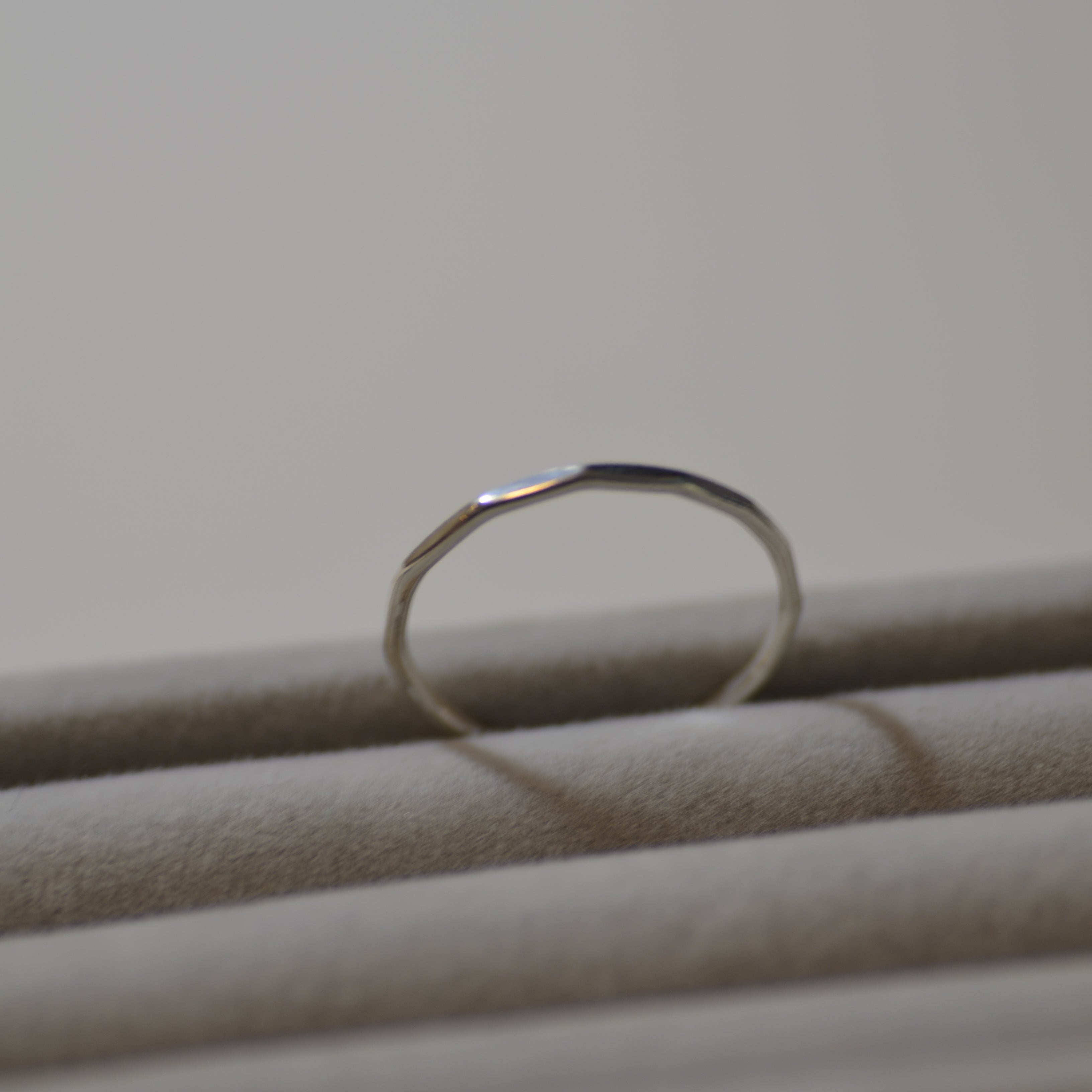 Close-up of a silver ring on a plain background