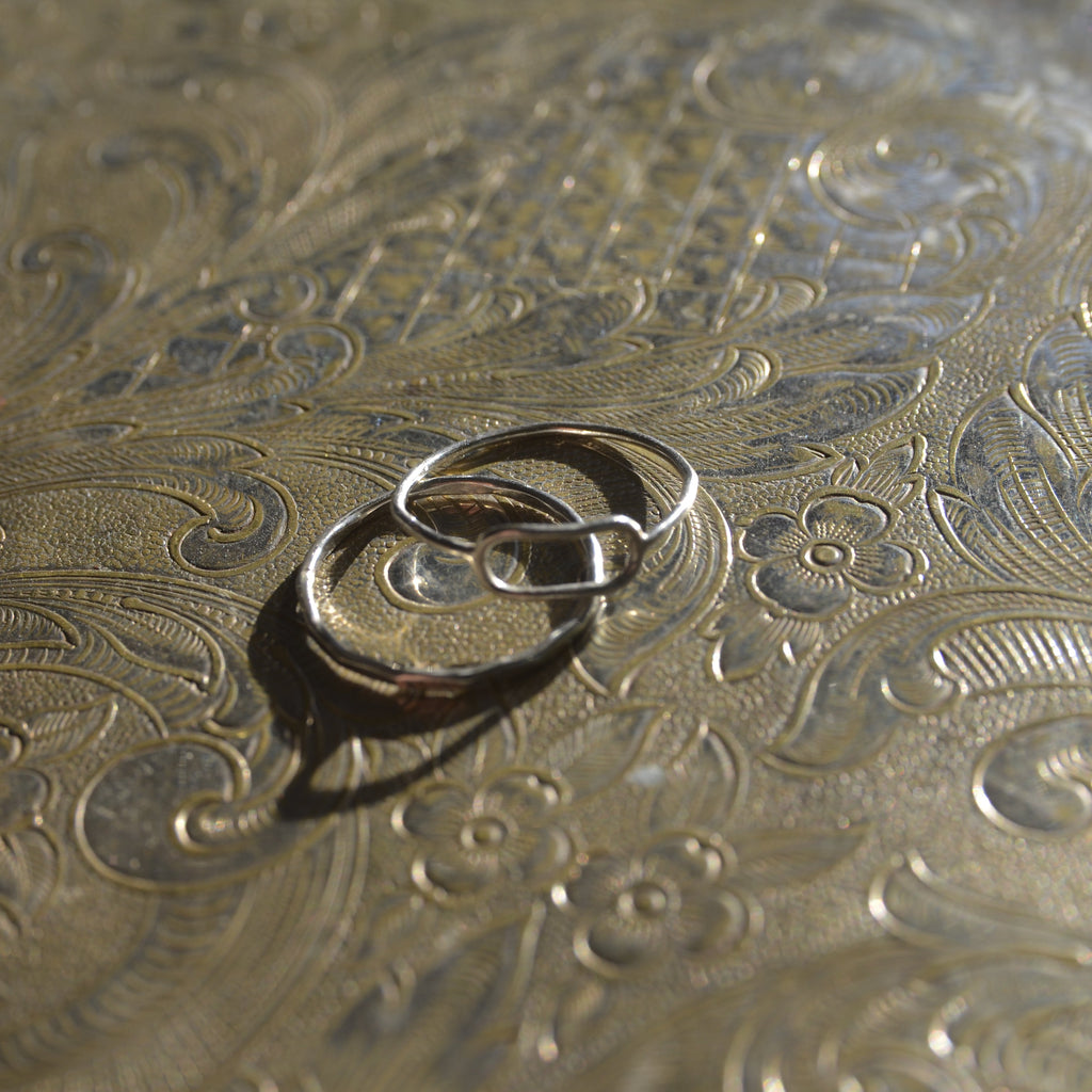 Silver ring on a textured gold surface