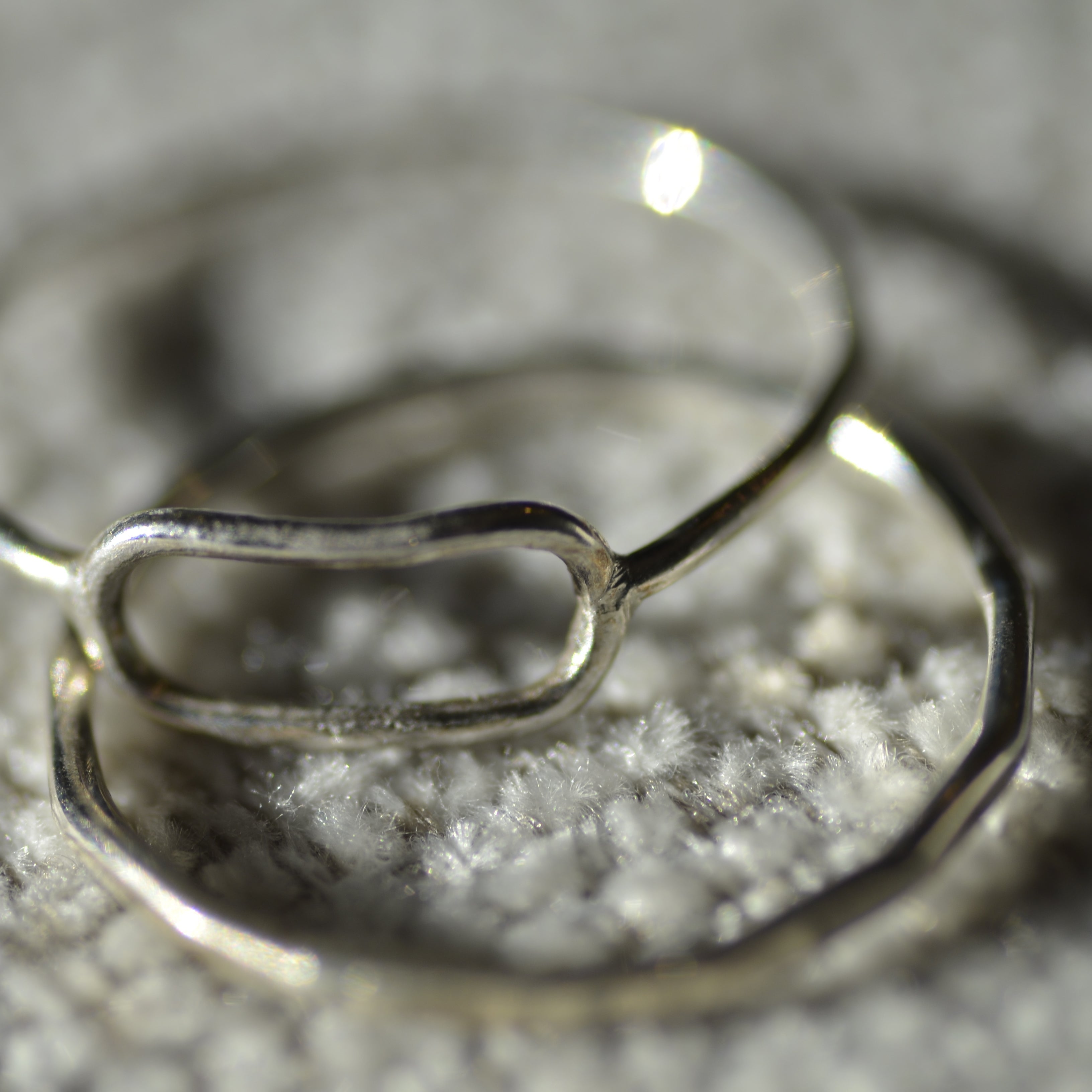 Silver ring on a textured surface